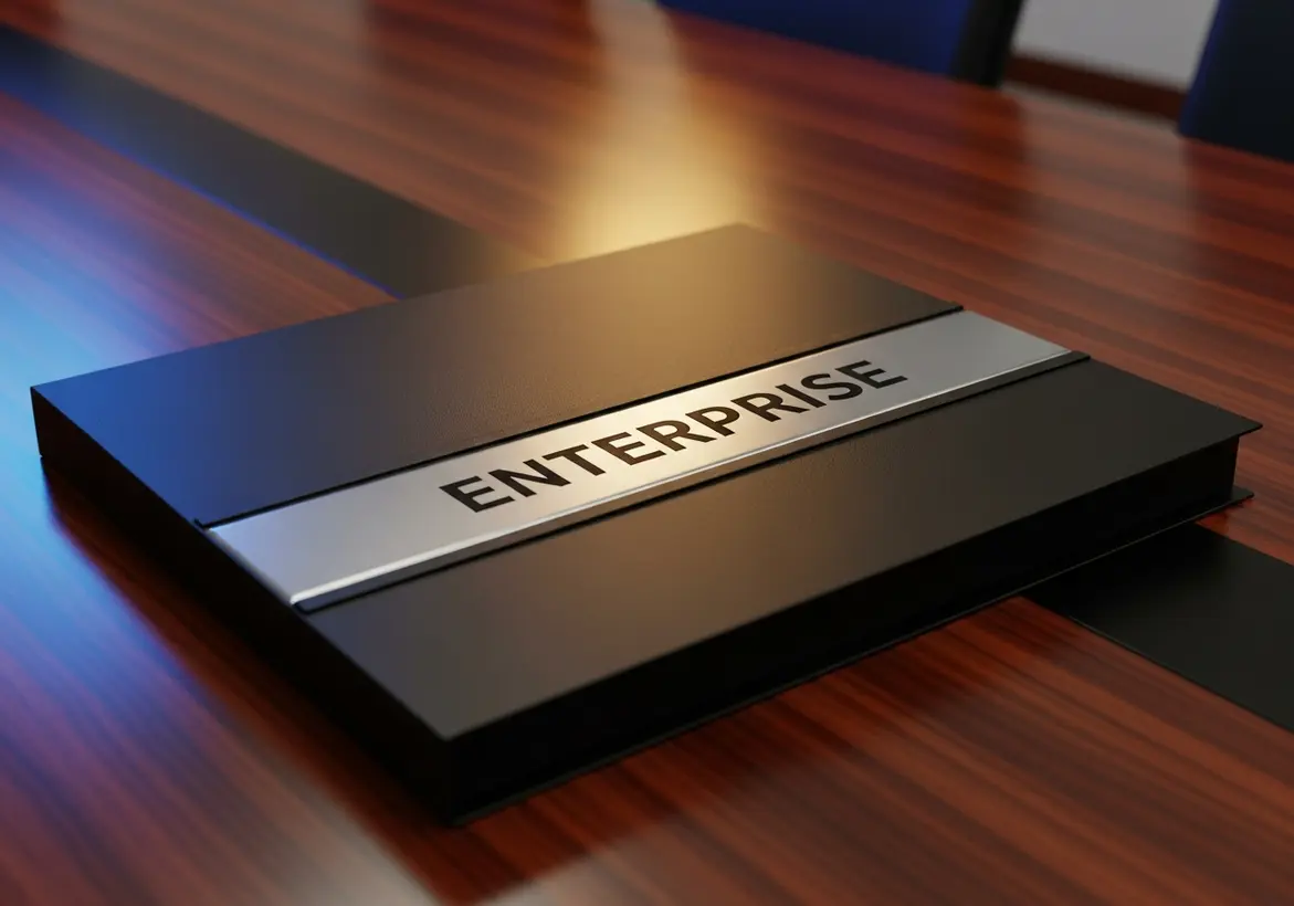 A professional black leather business binder featuring a sleek metallic plate engraved with the word "ENTERPRISE," resting on a polished wooden boardroom conference table.